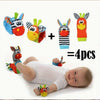 Four soft baby wrist rattles and foot finder socks for newborns displayed next to a baby.