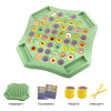 A green flip chessboard game with numerous fruit stickers and chess pieces.