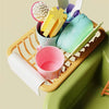 A kids electric kitchen sink playset featuring various colorful utensils and a pink cup in a green basin.