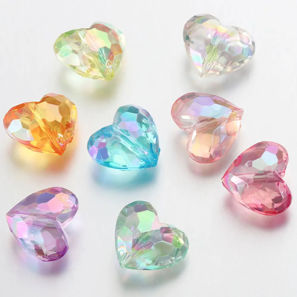 A collection of twenty acrylic heart-shaped beads in various shades of pink, green, and blue for jewelry making.