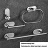 A set of four silver stainless steel towel rings and a storage rack with adhesive mounting for bathroom use.