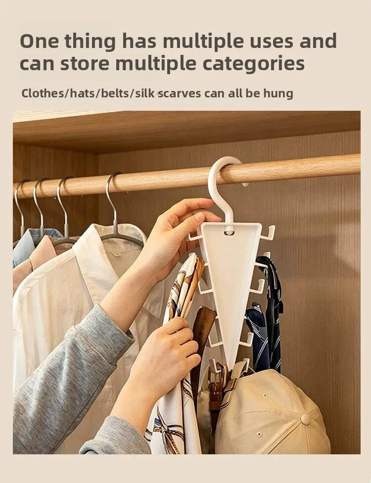 Hands hanging silk scarves on a wooden hanger in a closet organizer.