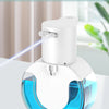 A white wall-mounted infrared automatic foam soap dispenser with a blue liquid reservoir and a thin mist nozzle.