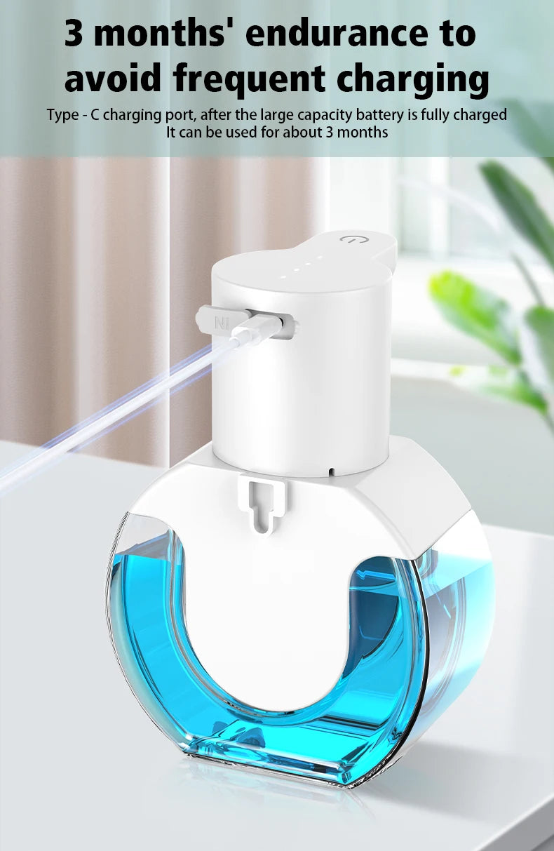 A white wall-mounted infrared automatic foam soap dispenser with a blue liquid reservoir and a thin mist nozzle.
