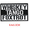 Black embroidered iron-on letter patches with white text reading Whiskey Tango Foxtrot