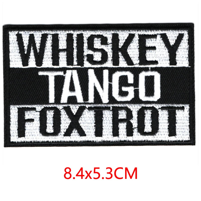 Black embroidered iron-on letter patches with white text reading Whiskey Tango Foxtrot