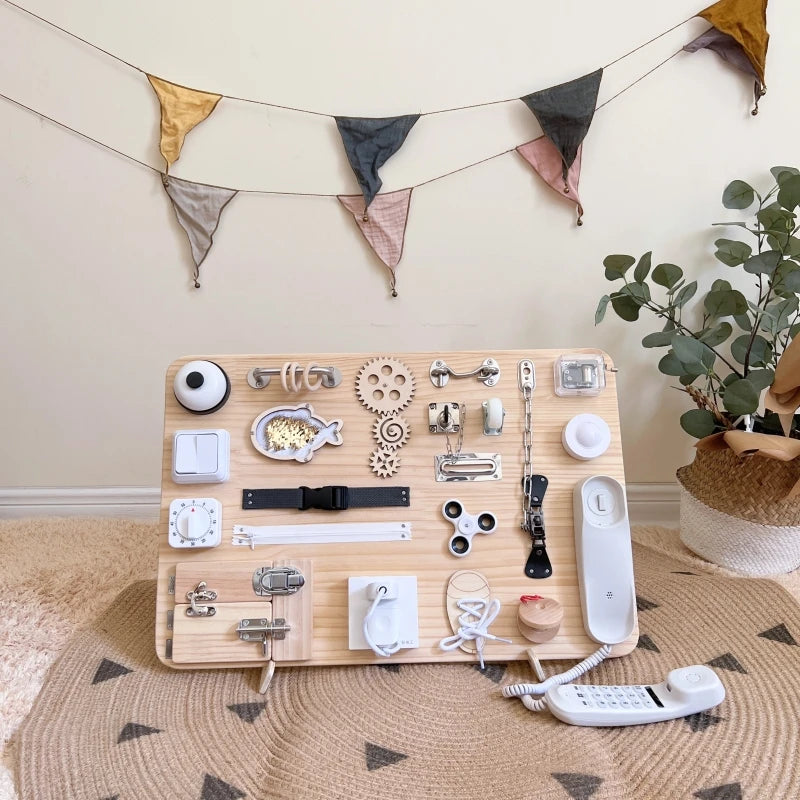 A wooden busy board featuring various Montessori parts and tools for fine motor skill development.