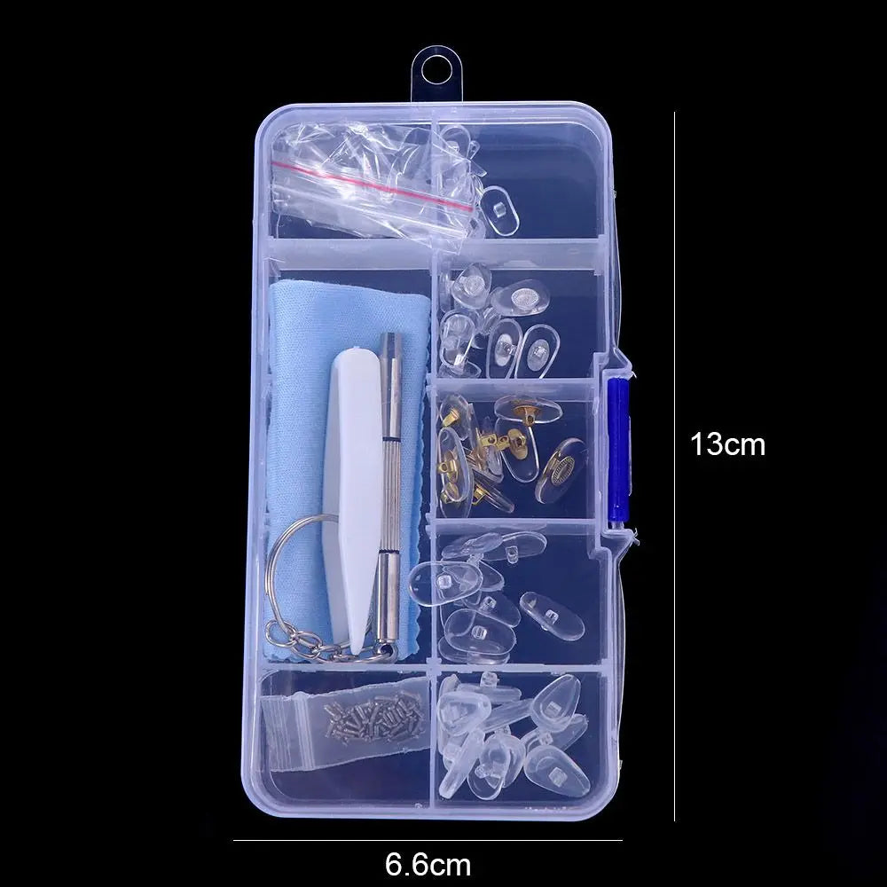 A clear plastic kit containing various tools and components for repairing glasses, including nose pads, screws, and precision