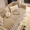 A beige plush sofa cushion cover featuring a quilted texture and decorative throw pillows.