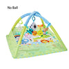 A green baby play gym mat with hanging toys including a dinosaur, a yellow animal, and a small stuffed animal.