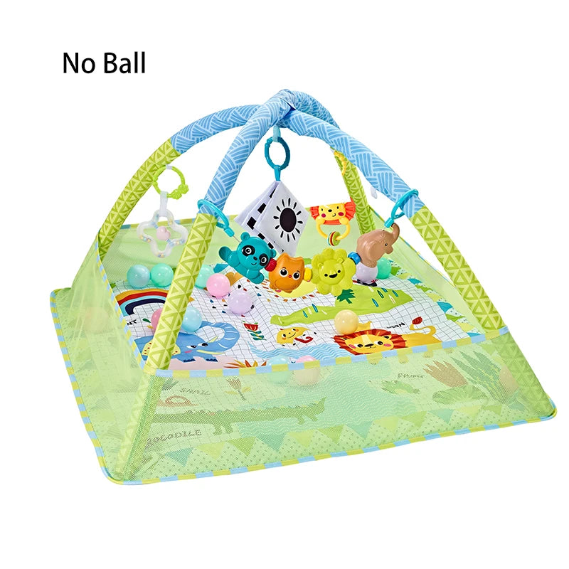 A green baby play gym mat with hanging toys including a dinosaur, a yellow animal, and a small stuffed animal.