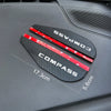 Black Compass rain guard visor with red accents shown on a dark vehicle surface.