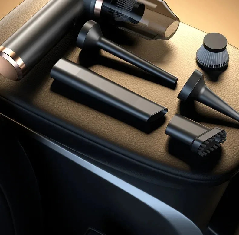 A collection of black and bronze cordless vacuum attachments resting on a dark surface.