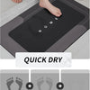 A black natural diatomium mud floor mat is shown in use on a bathroom counter, with a quick dry feature highlighted.