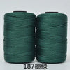 Two spools of dark green 3-ply polyester knitting yarn for crochet and hand crafts