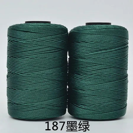 Two spools of dark green 3-ply polyester knitting yarn for crochet and hand crafts