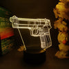 A glowing wireframe gun-shaped night light illuminates a book and flowers.