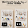 A white desktop pegboard organizer with shelves and hooks for organizing workspace tools
