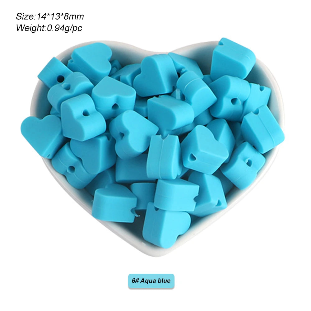 A pile of light blue silicone crown star heart beads for DIY jewelry making
