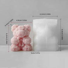 A pink silicone mold shaped like a bear, used for making candles, soap, and resin crafts.