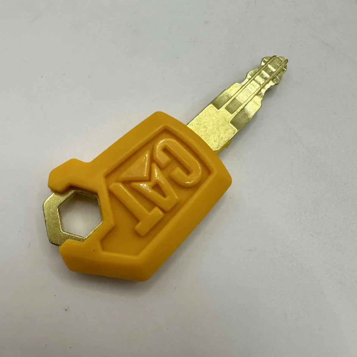 A yellow plastic ignition key set for Caterpillar excavators with a metal key blade.