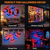 Halloween decor featuring glow-in-the-dark bat wall stickers with LED lights displayed on a home wall, window, and garage doo