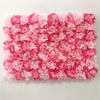 A dense wall panel made of pink silk rose flowers for weddings and events.