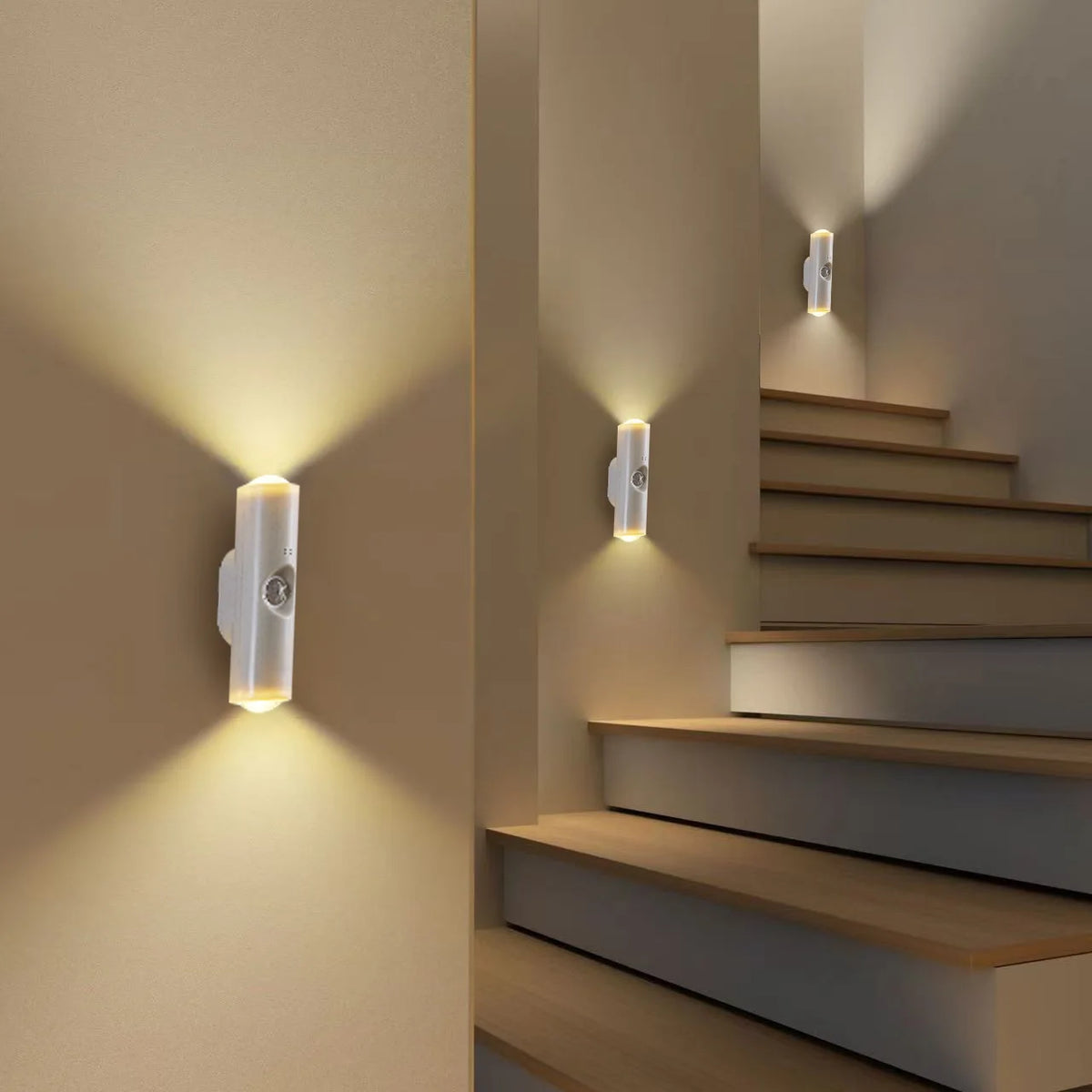 A modern interior wall sconce with a cylindrical white light illuminates a staircase area.