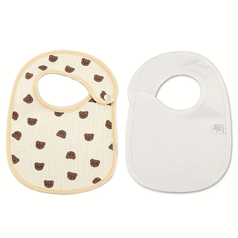 A pair of baby cotton gauze bibs with a patterned front and a solid white backing.