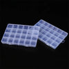 A clear plastic storage box with multiple compartments and fixed dividers is shown against a black background.