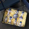 A collection of handcrafted astronaut figurine resin spaceman desk decor figures displayed in a dark box.