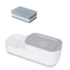 A white countertop soap dispenser with a built-in sponge holder and a light blue sponge.