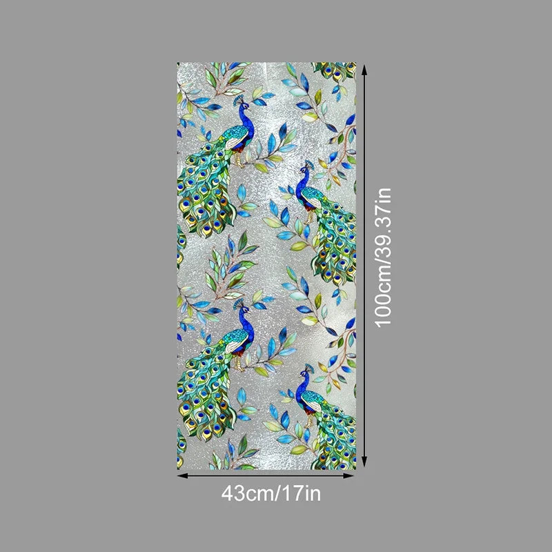 Vertical roll of floral stained glass window film featuring vibrant green and blue peacock designs on a silver background