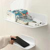 A white foldable no-drill wall shelf holding various items including a phone, glasses, and toiletries.