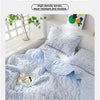 A light blue quilted blanket with a floral pattern is shown folded on a bed, emphasizing silky and naked, unrestrained sleepi