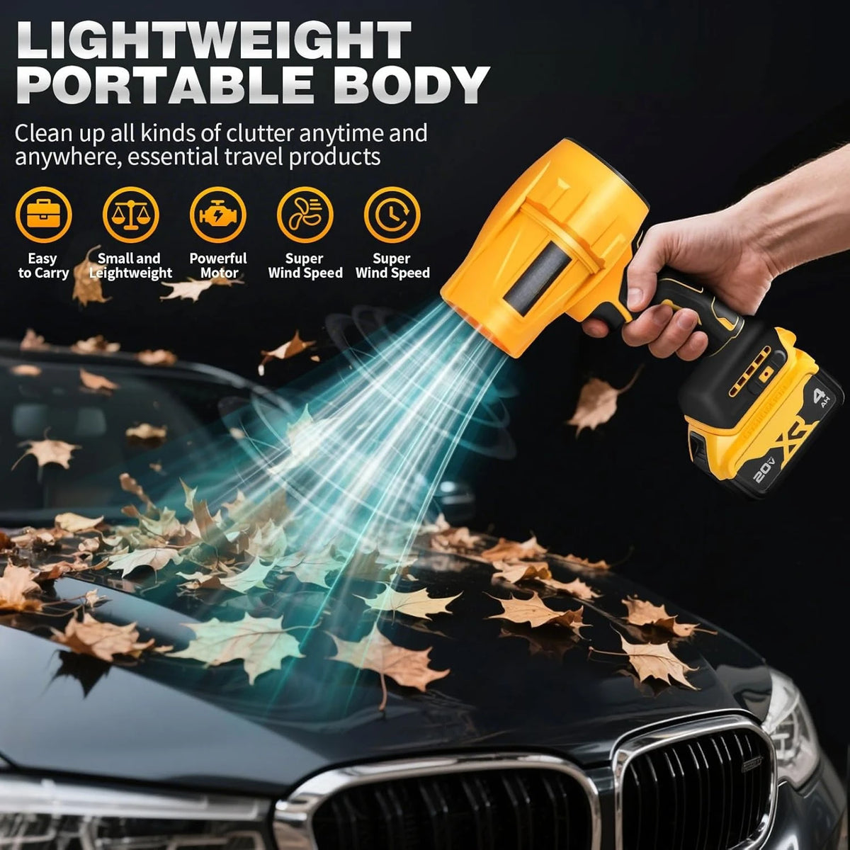 A hand holds a yellow cordless handheld air blower cleaning fallen leaves off a car's surface.
