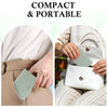 A close-up of a light mint green slim bi-fold wallet being held by a woman, emphasizing its compact and portable design.