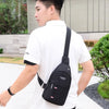 A man wearing a white t-shirt and black fanny pack is shown outdoors.
