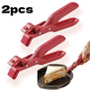 Two red silicone clips used to grip a sandwich in a dark bowl.