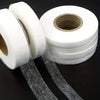 Rolls of white no-sew iron-on hem tape for instant clothing repairs with strips unwound.
