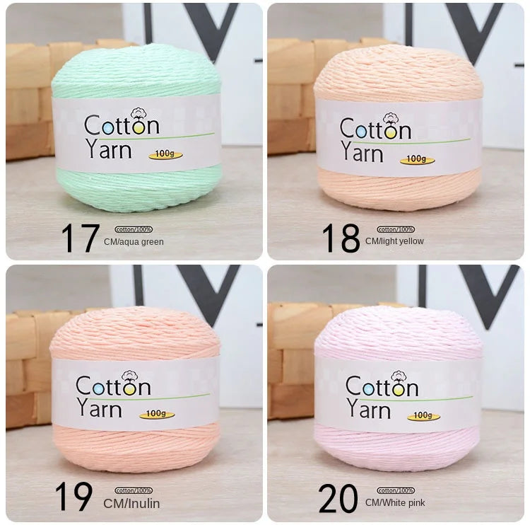A set of five skeins of soft cotton yarn in various colors including aqua green, light yellow, pink, and white.