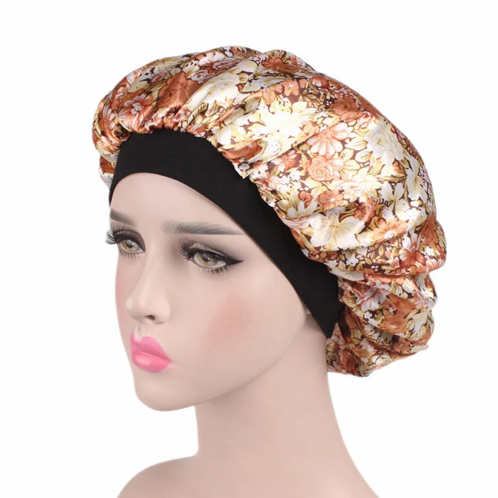 A woman wearing a satin hair bonnet with an ornate floral pattern and a black elastic band.