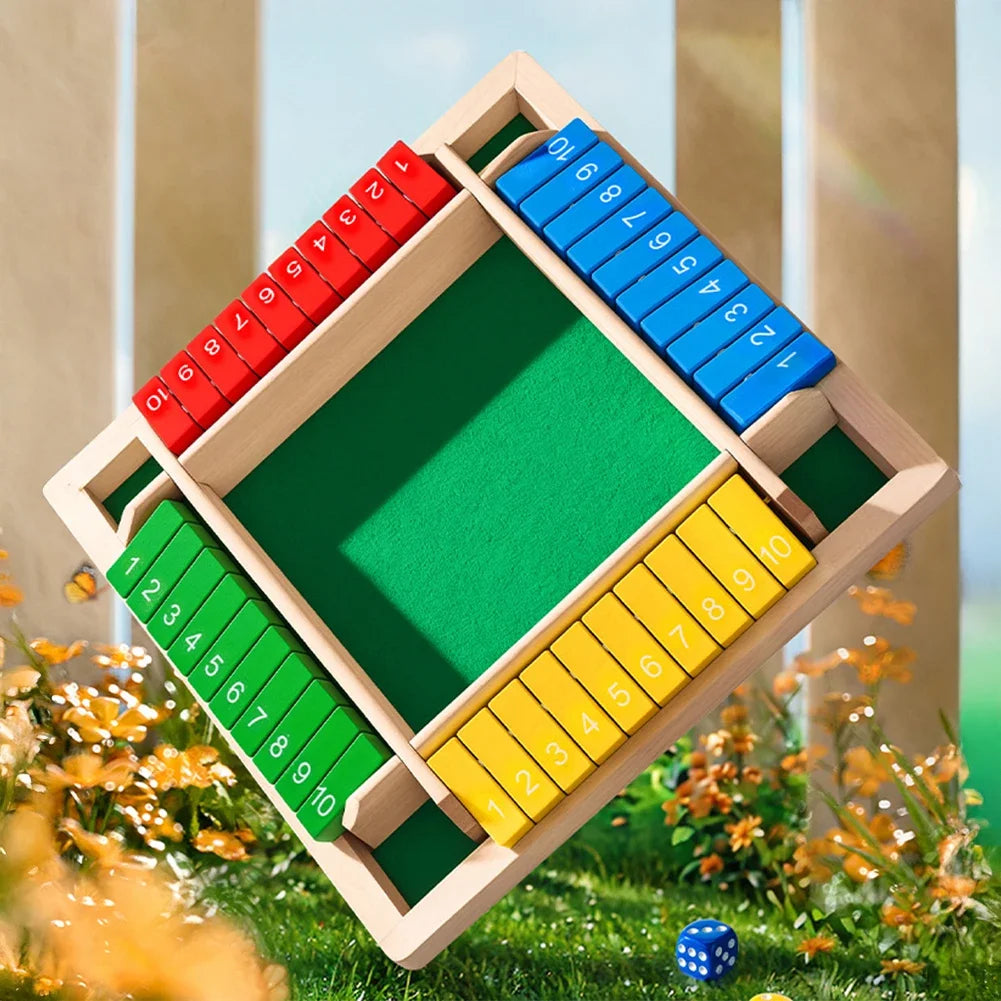 A wooden shut the box dice game with colored dice arranged in a diamond shape on green felt.