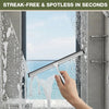 A hand uses a soft silicone shower squeegee to remove water streaks from a window pane.