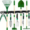 A wall-mounted tool rack displaying a green broom, shovel, and various hand tools like shears and forks.