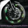 Close-up of a motorcycle wheel rim with colorful reflective stickers for night safety and style
