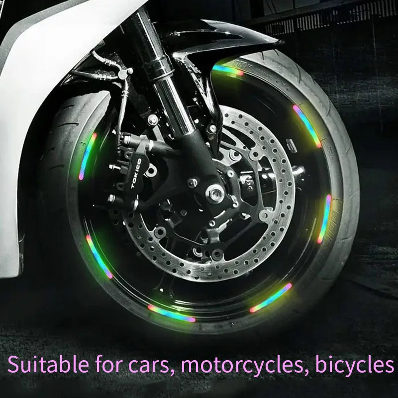 Close-up of a motorcycle wheel rim with colorful reflective stickers for night safety and style