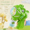 A green dinosaur bubble gun with lights is shown being used to blow bubbles.