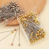 A clear plastic container holds a pack of precision quilting pins in silver and gold colors.