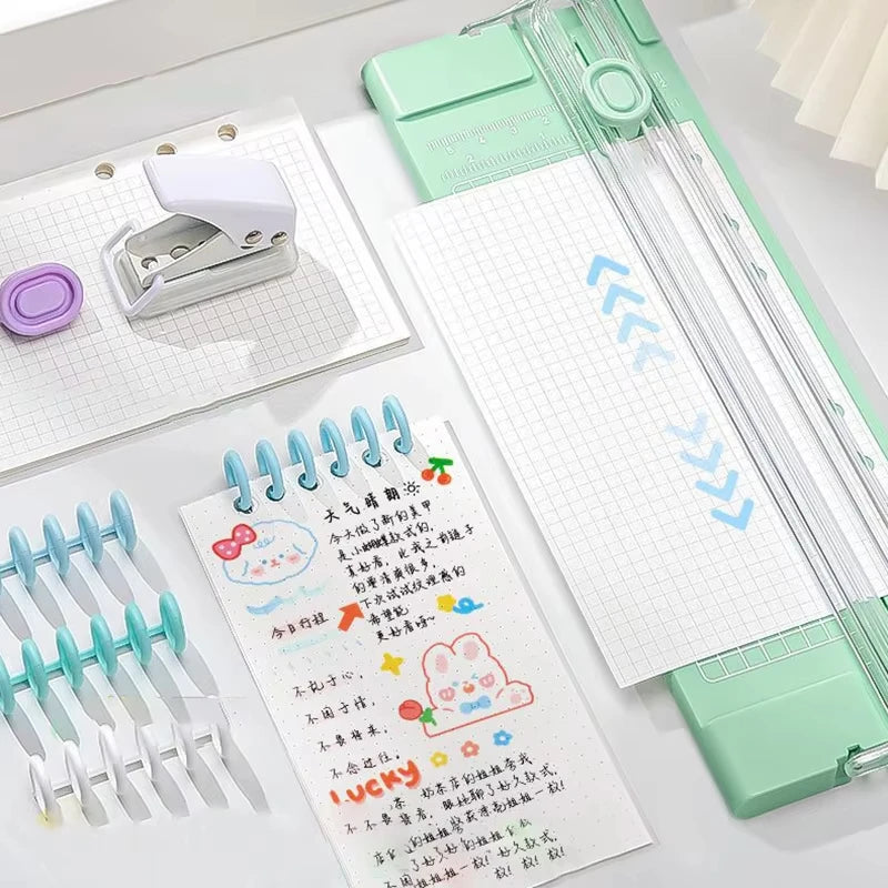 A close-up of an A4 mini paper trimmer with precision cutter in mint green and silver, showing the trimming blades and paper.